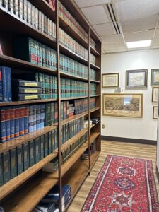 Kendall Page Law Library Law library shelves with legal reference books and historical Durham map at Kendall Page office
